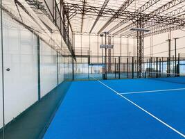 Padel court with lines and net indoor photo