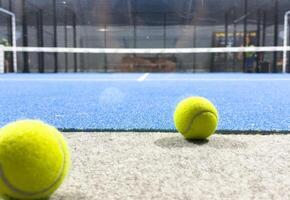 Blue paddle court, with balls. With view of the net and the lines photo