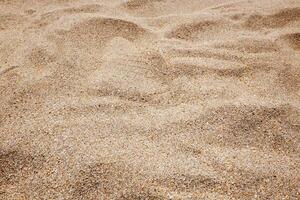 Texture and background of beige beach sand in natural of summer. Top view photo