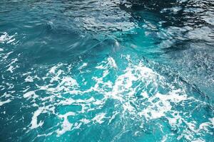 Calm sea with foam waves and splash water background and destination travel summer ocean photo