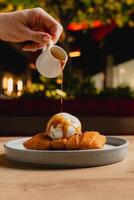 Cheese strudel with ice cream and caramel sauce drizzling on top. photo