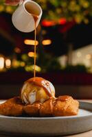 Cheese strudel with ice cream and caramel sauce drizzling on top. photo