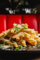 French fries topped with melted cheese and bacon bits. photo
