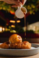 Cheese strudel with ice cream and caramel sauce drizzling on top. photo