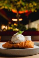 Cheese strudel with ice cream and caramel sauce drizzling on top. photo