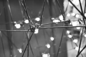 abstract background is a metal structure made of thin rods with light bulbs in a geometric sequence. strange art objects for home and office. High quality photo