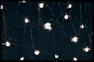 abstract background is a metal structure made of thin rods with light bulbs in a geometric sequence. strange art objects for home and office. High quality photo