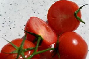 tomatoes are shown on a white surface photo