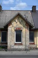 an old building with a broken window photo