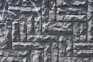 a wall made of stone with a pattern of squares photo