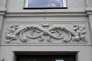 a decorative carving on the side of a building photo