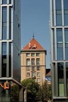 a man is standing on a ladder in front of a building photo