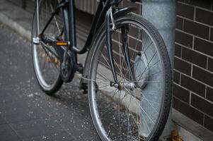 a bicycle is parked against a brick wall photo