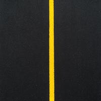 A black road with yellow lines on it photo