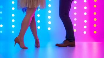 Two people in high heels standing in front of a colorful background photo