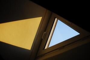 Looking at the sky through a window with a yellow triangle photo