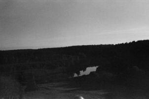 Black and white landscape photo with mountain in background