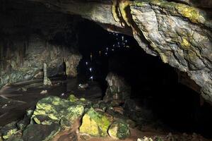 Visitors exploring the stunning Grutas de Cacahuamilpa National Park cavern at dusk photo