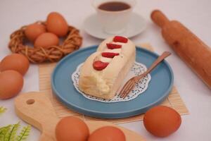 Strawberry cheese cake with cup of coffee on a table. photo