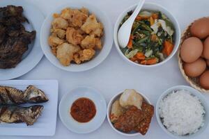 traditional Indonesian food arranged neatly on a white surface photo
