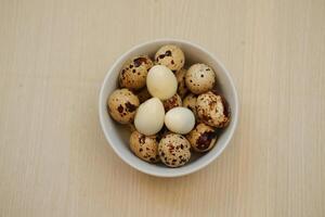 Quail eggs on a wooden table. Close-up, selective focus photo