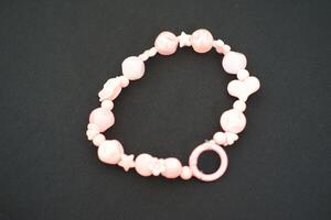 A beaded bracelet on a black surface. photo