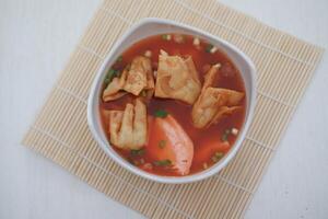 delicious red tofu soup with crackers photo