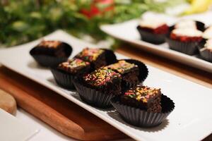 small cupcakes topped with frosting and colorful sprinkles photo
