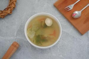 A bowl of soup on a marble table photo