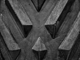 A diamond patterned wall with its textured surface and interplay of light and shadow enhancing the geometric design in picturesque black and white thus reveals intricate details in close ups. photo