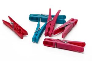 Colorful clothespins arranged playfully on a white surface in a creative display of everyday objects photo