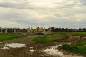 Construction site in an open field under cloudy skies during late afternoon breaks in a rural landscape photo