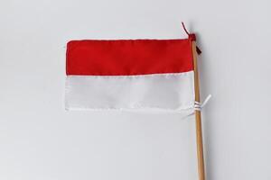 The red and white flag with a wooden pole photo