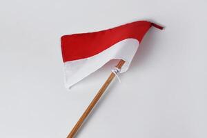 The red and white flag with a wooden pole is a symbol of the Indonesian nation photo