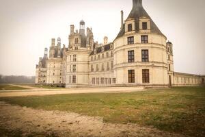 stunning vintage premise stands grandly with its intricate architecture, surrounded by lush greenery under a misty sky, exudes elegance and captures the beauty of timeless architecture photo