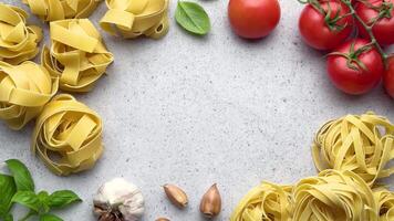 Tagliatelle pasta forming frame with tomatoes and garlic video