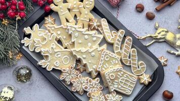 Christmas cookies with white icing displayed on a black baking sheet video