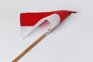 The red and white flag with a wooden pole is a symbol of the Indonesian nation photo