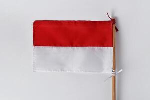 The red and white flag with a wooden pole photo