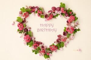 Heartshaped botanical frame with copy space. Floral background with text. Happy birthday photo
