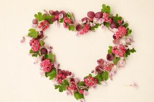 Heartshaped botanical frame with copy space. Floral background with place for text photo