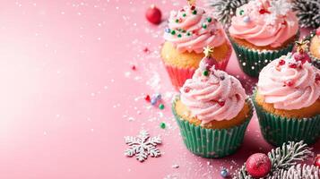 Christmas cupcakes with pink frosting on pink background photo