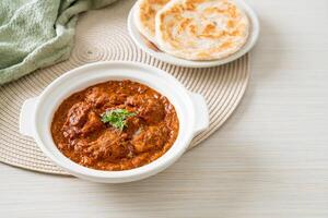 chicken tikka masala spicy curry meat food with roti or naan bread photo