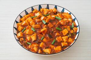 Mapo Tofu - The traditional Sichuan dish of silken tofu and ground beef, packed with mala flavor from chili oil and Sichuan peppercorns. photo