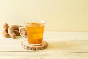 Delicious sweet drink tamarind juice and ice cube photo