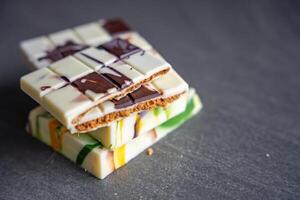 Piece of trend Dubai white chocolate with halva paste. Confectionery handmade sweets at home in the kitchen. High quality photo