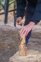 Chopping wood for the fire with an axe. A man's hand with an axe chopping wood. High quality photo