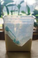 Green scoop resting in a container of flour, ready for baking preparations. High quality photo