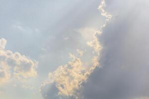 Background heaven with expressive textures of clouds and rays of the sun photo