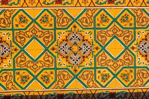 Colorful vintage surface with an old oriental pattern. The background is a texture that has a decorative value. For overlay or texture designs photo
